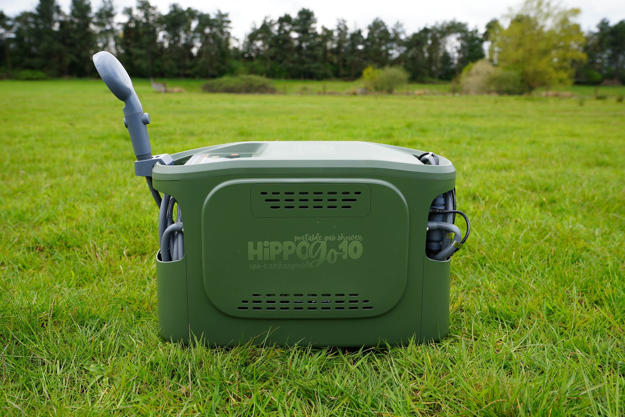 Green Hippo Go  on grass with trees in the background