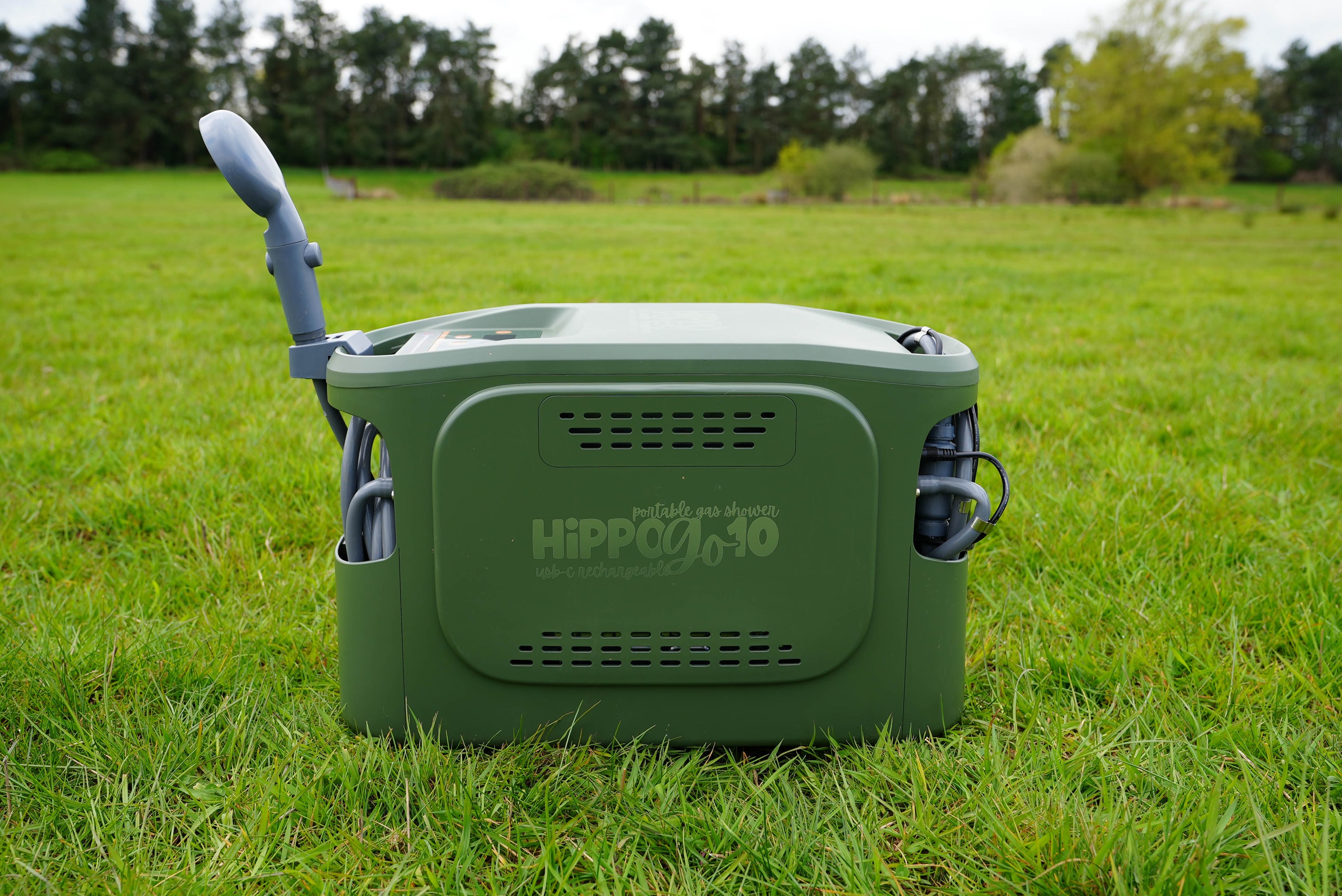 Green Hippo Go  on grass with trees in the background