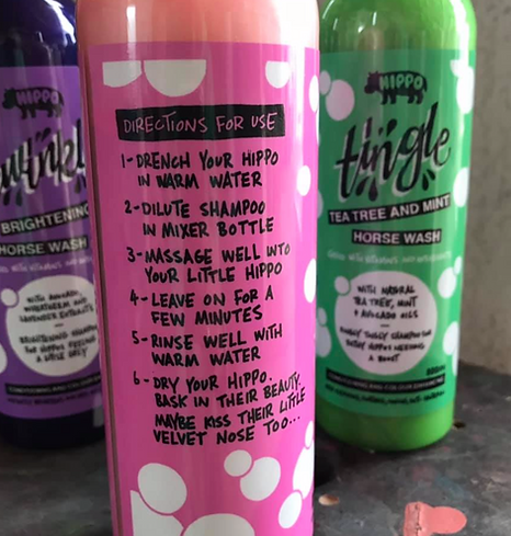 Three bottles of Hippo  horse wash with labels on a gray surface.