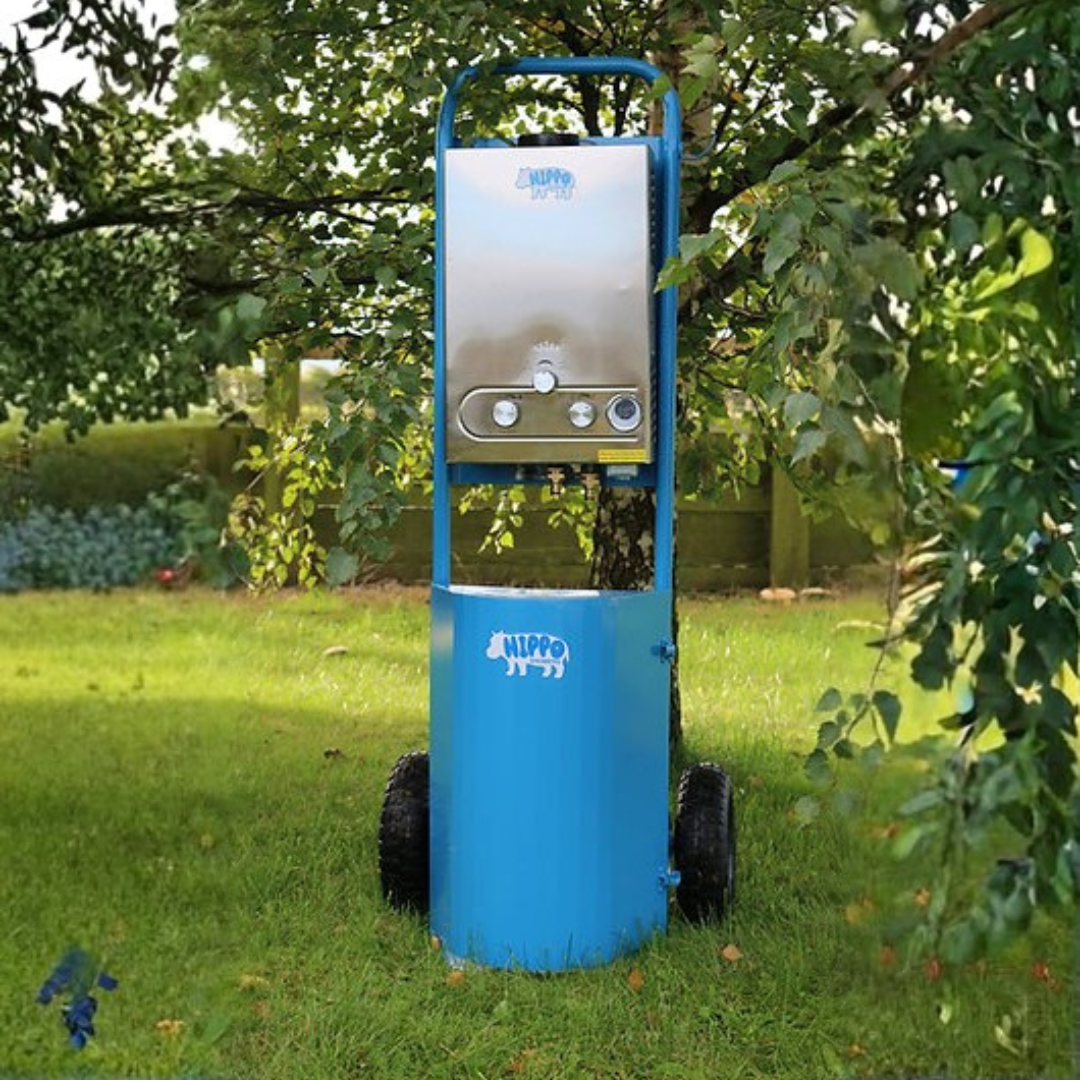 Blue and silver machine labeled 'Hippo' on a grassy area with trees in the background