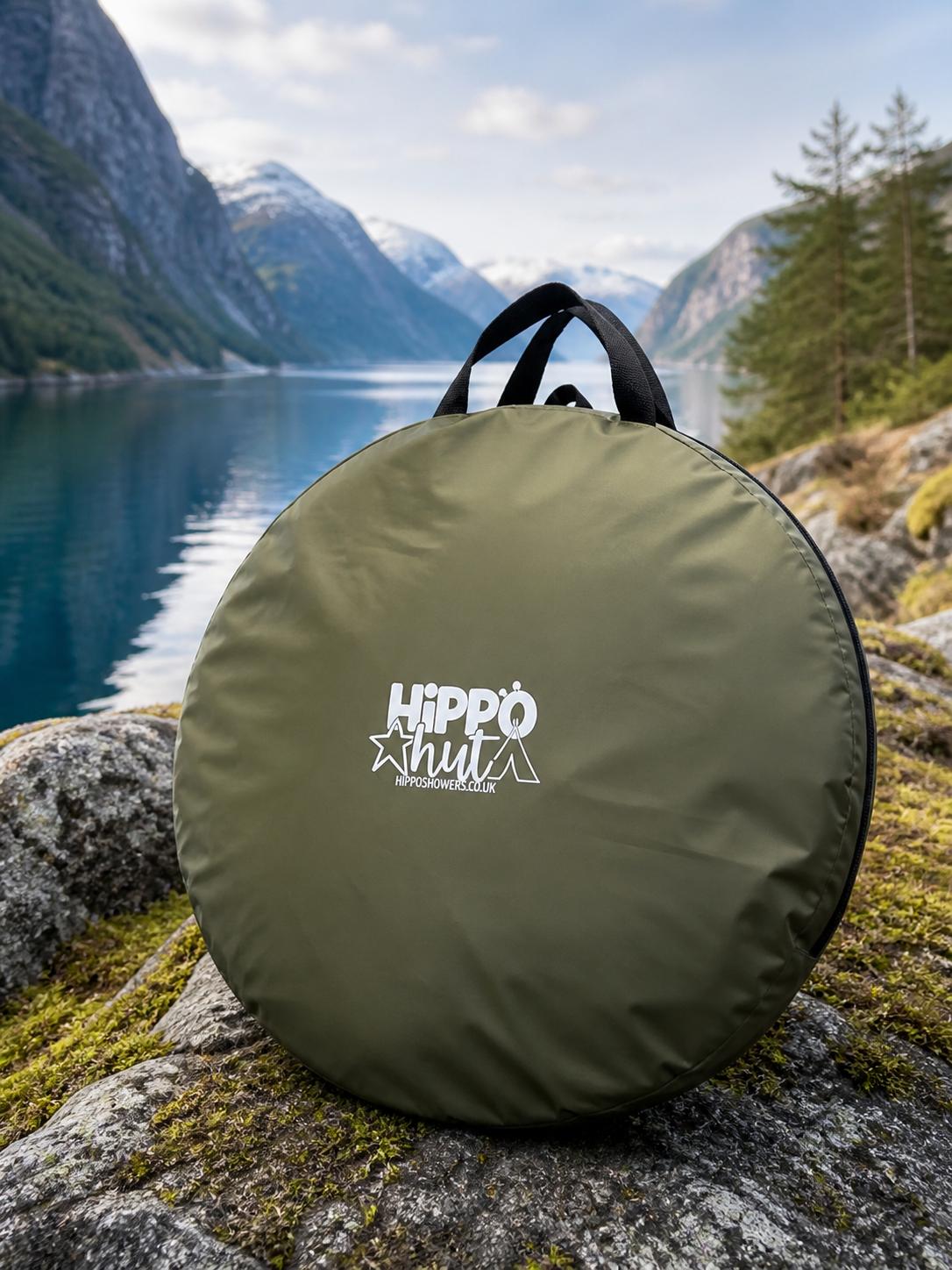 Green bag with Hippo Mylty logo on a rock with a scenic mountain and lake background