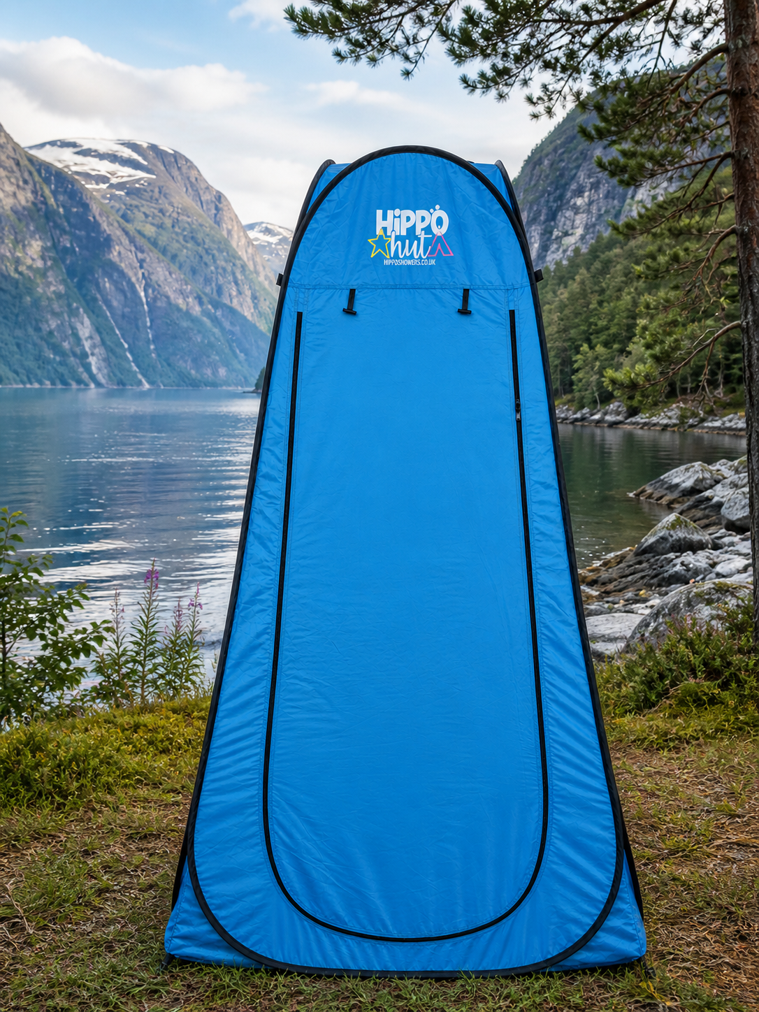 Blue pop-up tent with 'Hippo' branding in a natural setting with mountains and water.