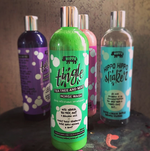 Four bottles of Hippo products including 'Tea Tree and Mint Horse Wash' on a textured surface.