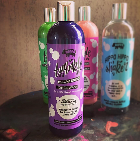 Purple bottle of Hippo Twinkle Shampoo with other colorful shampoo bottles in the background.